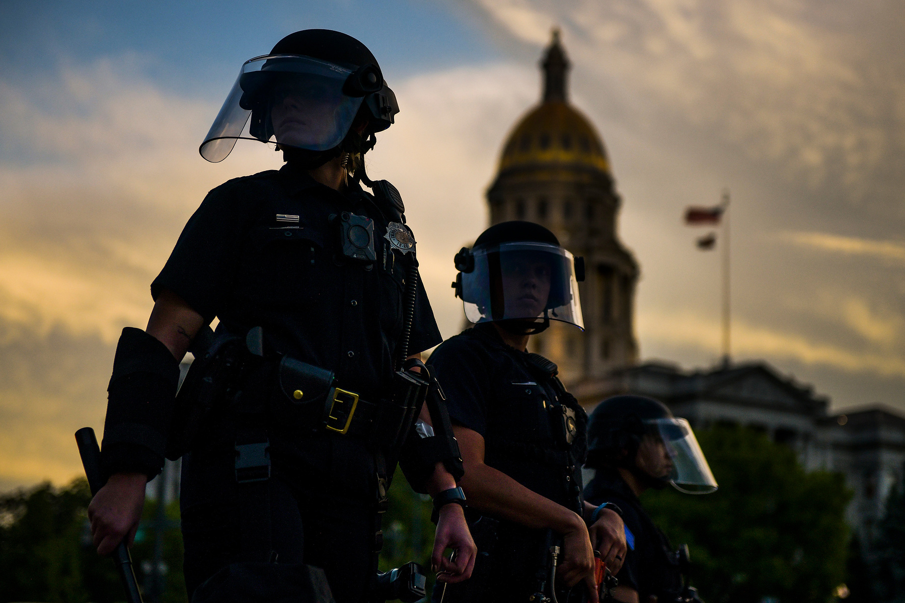 DENVER, CO - MAY 29: Police officers watch over a crowd of hundreds of people protesting the death of George Floyd next to the Colorado state capitol on May 29, 2020 in Denver, Colorado. This was the second day of protests in Denver, with more demonstrati