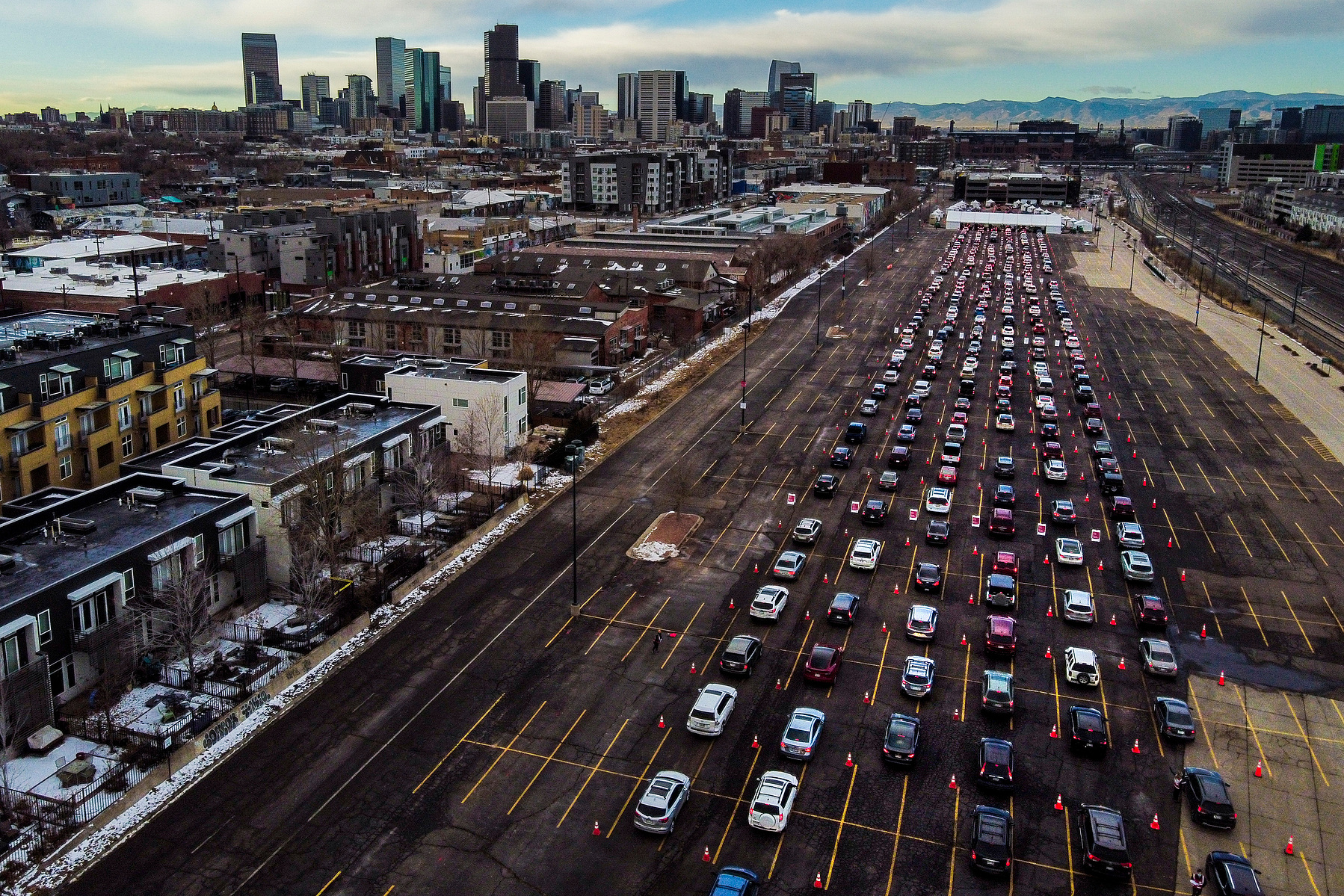 DENVER, CO - JANUARY 30: Cars line up for a mass COVID-19 vaccination event on January 30, 2021 in Denver, Colorado. UCHealth, Colorado’s largest healthcare provider, plans to vaccinate 10,000 seniors over 70 during the drive-up event this weekend. (Photo