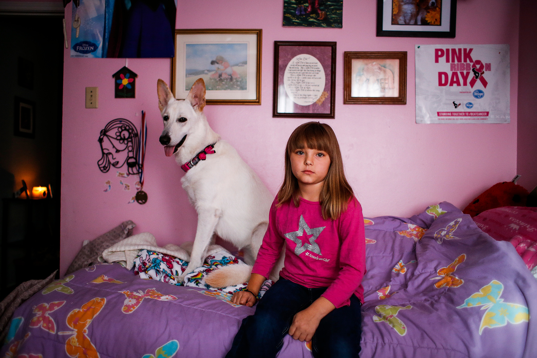 Ava Pettit, 8, sits for a portrait with the family dog, Zoe, in her room Tuesday, June 27, 2017 in Webster. About a year ago Zoe bit Ava in the face while jumping for a treat. Ava's parents rushed her to a hospital in their insurance network, but while th