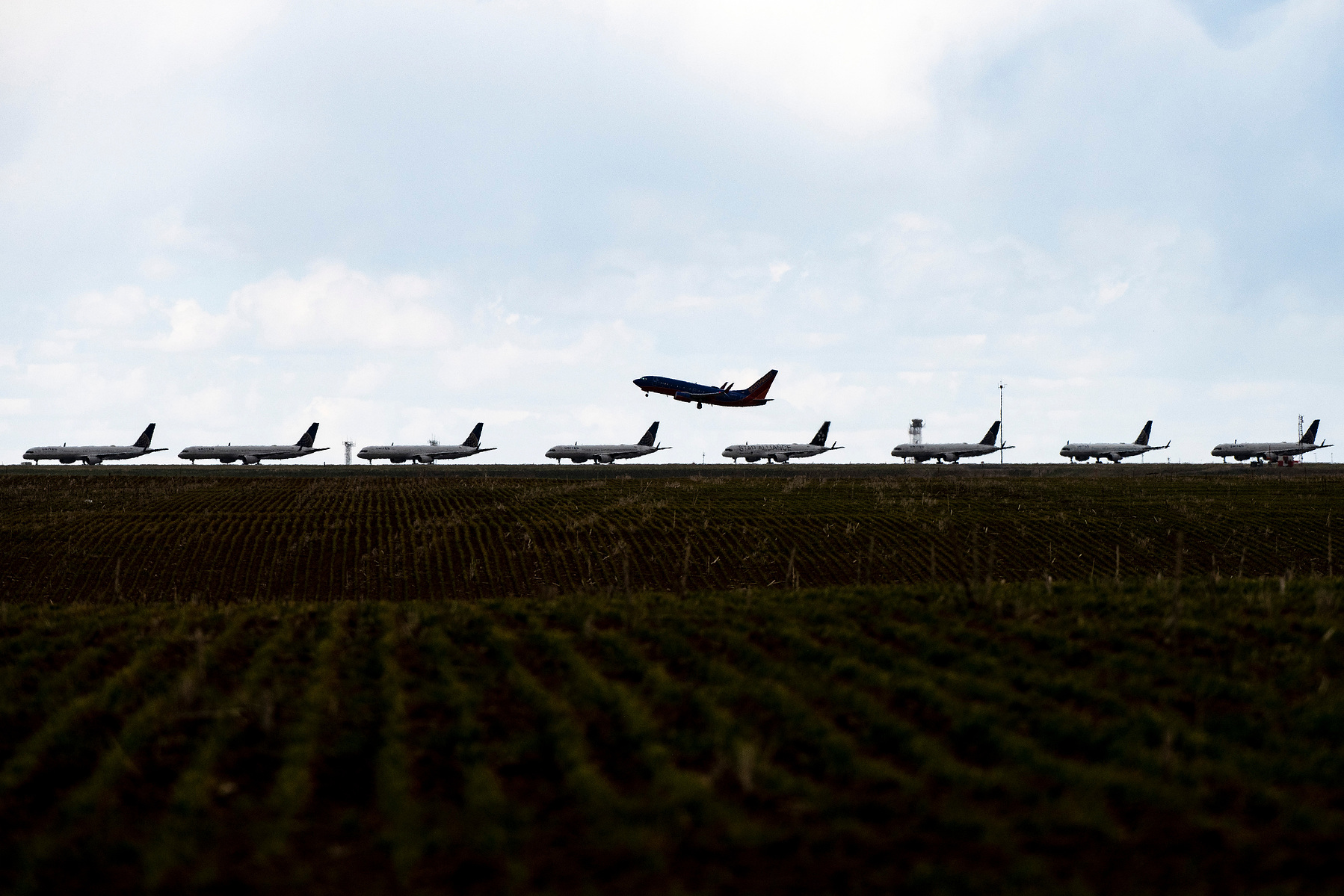 DENVER, CO - APRIL 22: A Southwest Airlines flight takes off as United Airlines planes sit parked on a runway at Denver International Airport as the coronavirus pandemic slows air travel on April 22, 2020 in Denver, Colorado. Compared to the same time las
