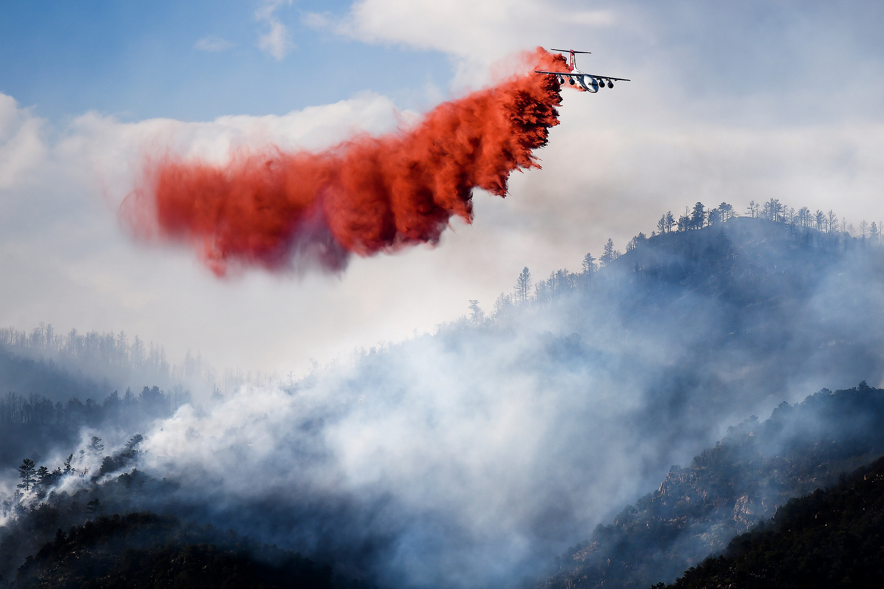 A slurry bomber makes a drop on the Eightmile fire Friday, June 27, 2014. The fire, which has grown to 700 acres, is burning north of Canon City, Colo.