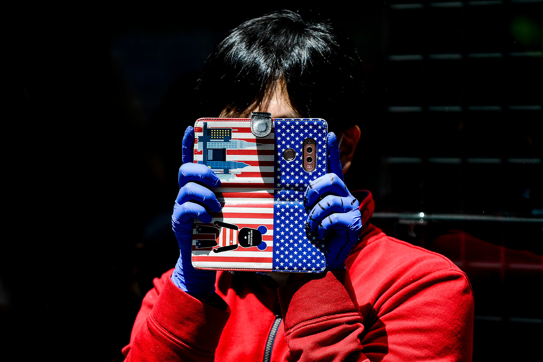 DENVER, CO - MAY 30: A man takes a photo as thousands of people march down the 16th Street Mall to protest the death of George Floyd on May 30, 2020 in Denver, Colorado. The city of Denver has enacted a curfew starting Saturday night and Governor Jared Po