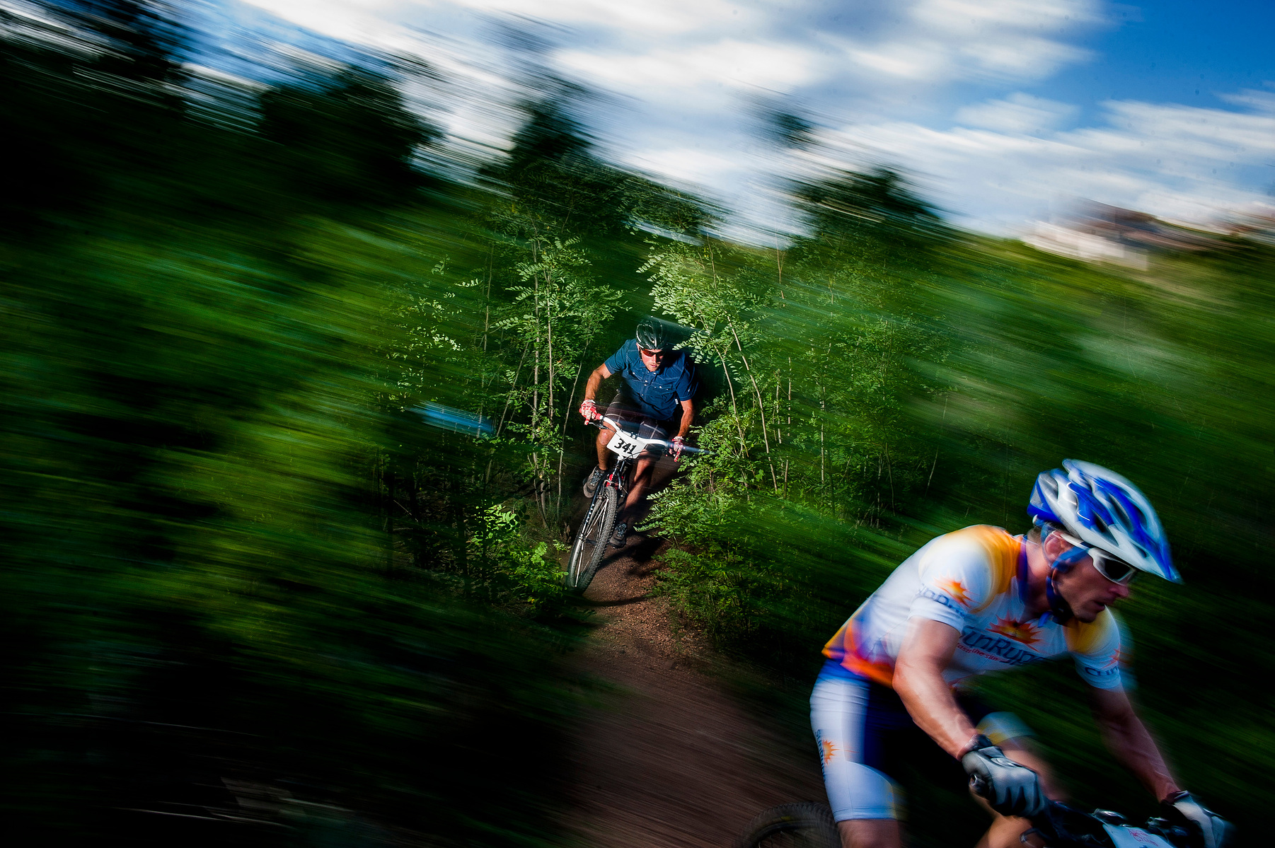 Category 2 30-39 Men racer Daniel Byrd chases another racer out of the woods in Bear Creek Terrace during the final race of the Ascent Cycling Series Wednesday, July 31, 2013. Byrd placed first in his division with a time of 40:35. Michael Ciaglo, The Gaz