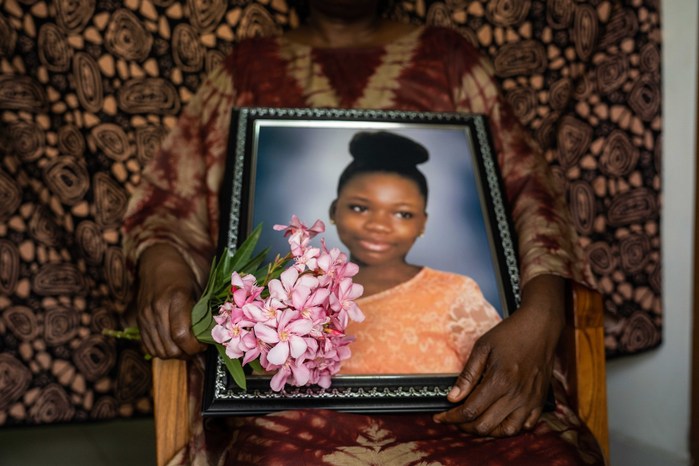 Vivian Akpagher, the mother of Keren Happuch holds a portrait of her daughter who was raped leading to her death.