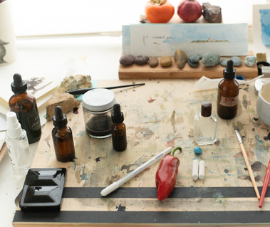 Paint worktable with miscellaneous paints and objects