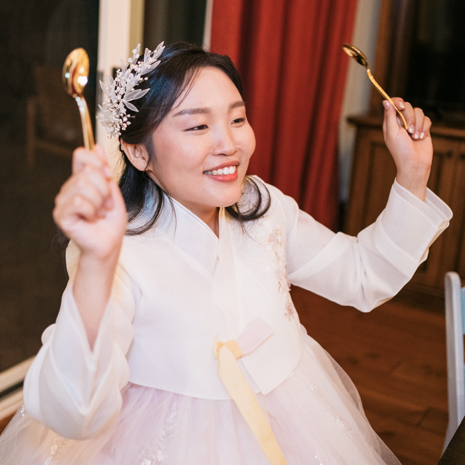 smiling bride played along with the music on her golden plastic spoons