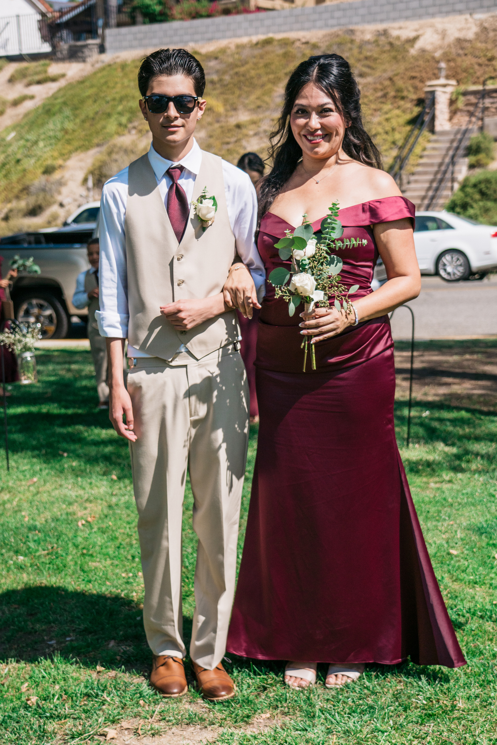 groomsman and maid of honor arm in arm