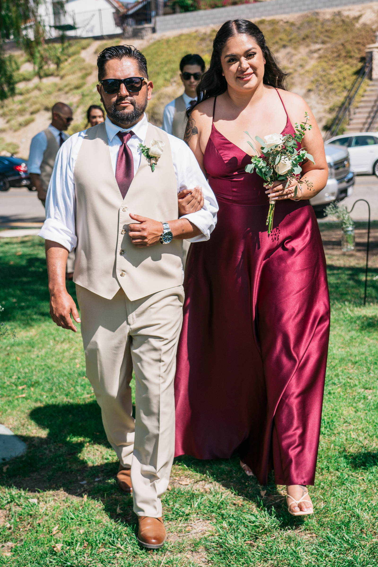 groomsman and bridesmaid arm in arm
