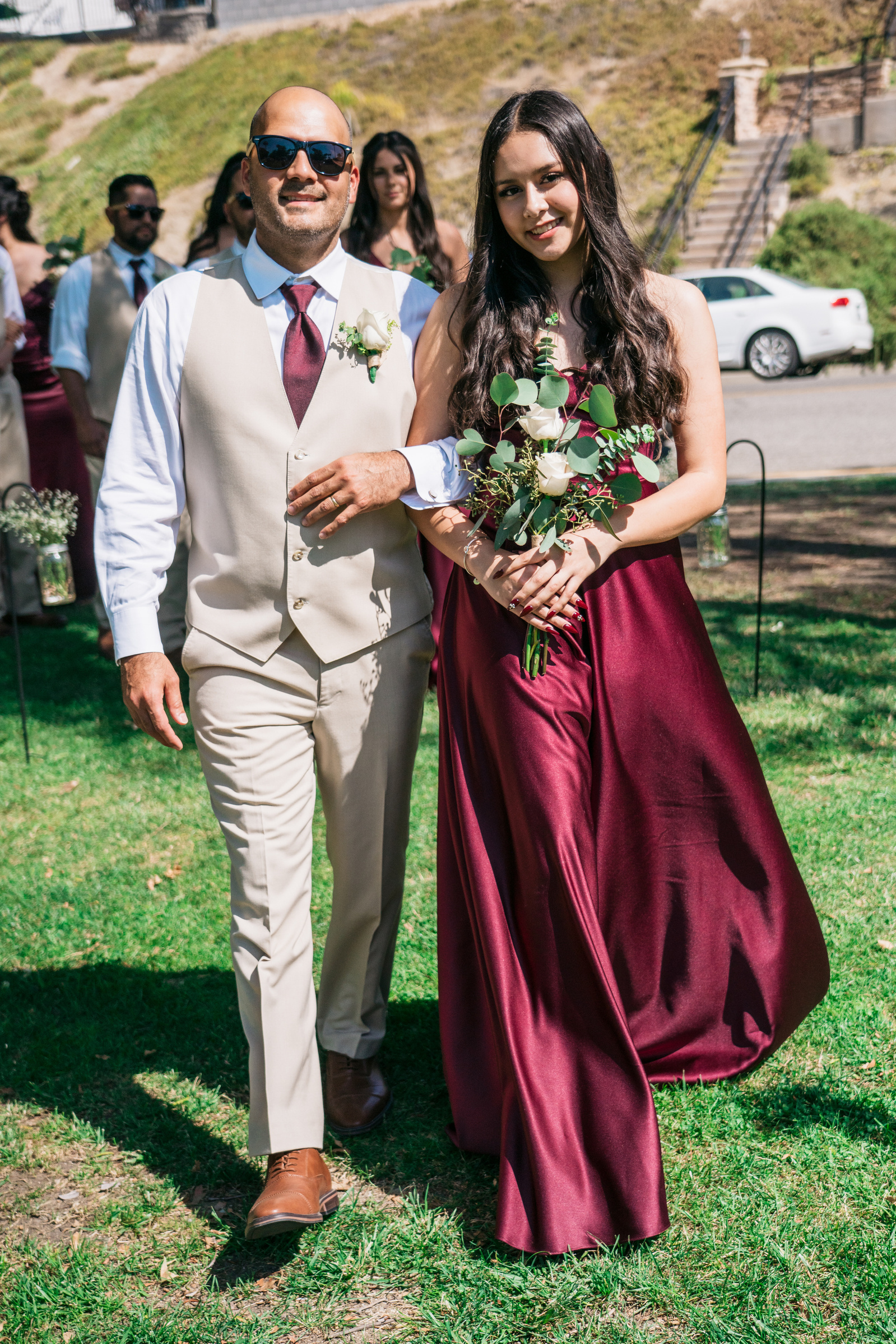 groomsman and bridesmaid arm in arm