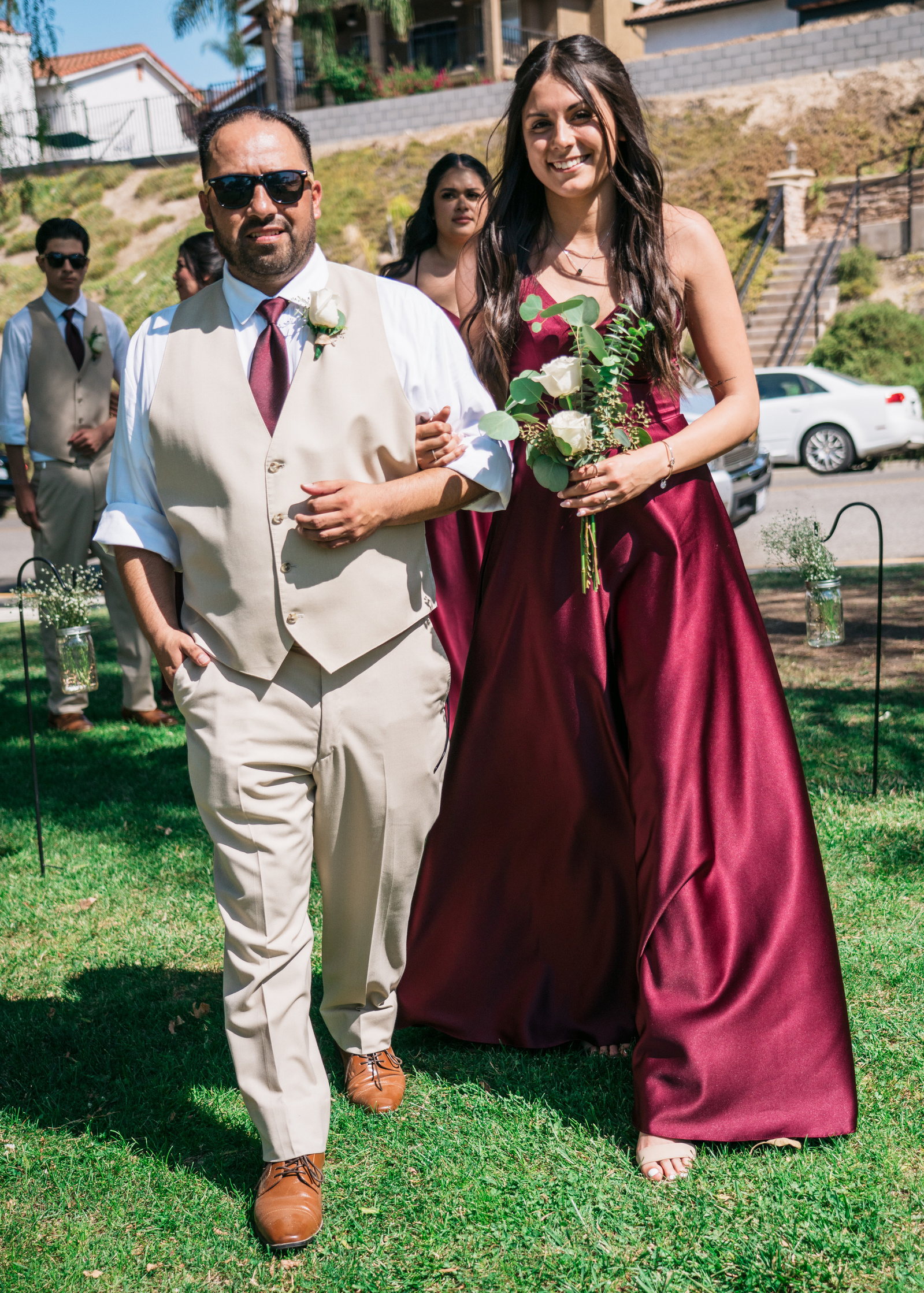 groomsman and bridesmaid arm in arm