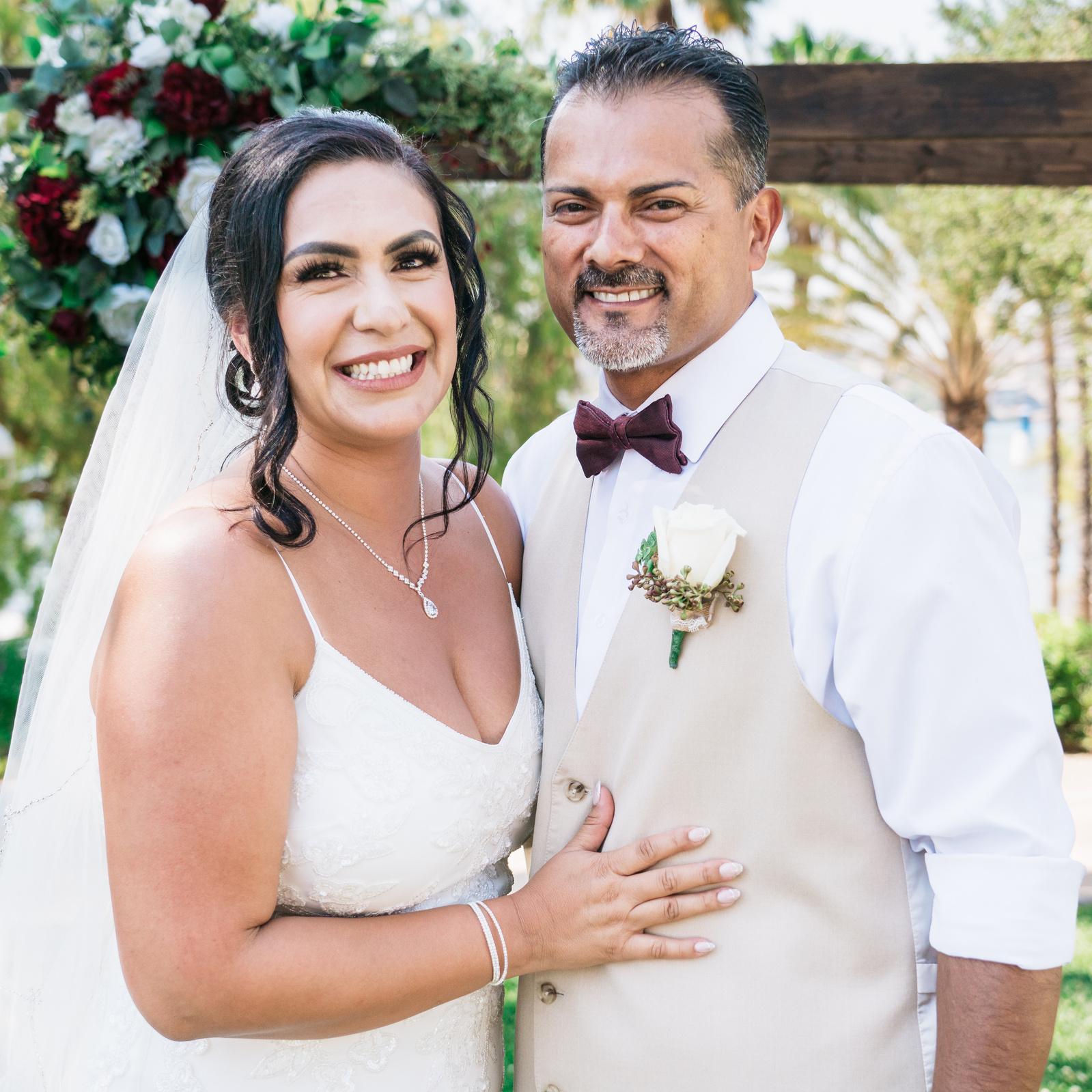 smiling portrait of the happy bride and groom husband and wife mr and mrs at the altar