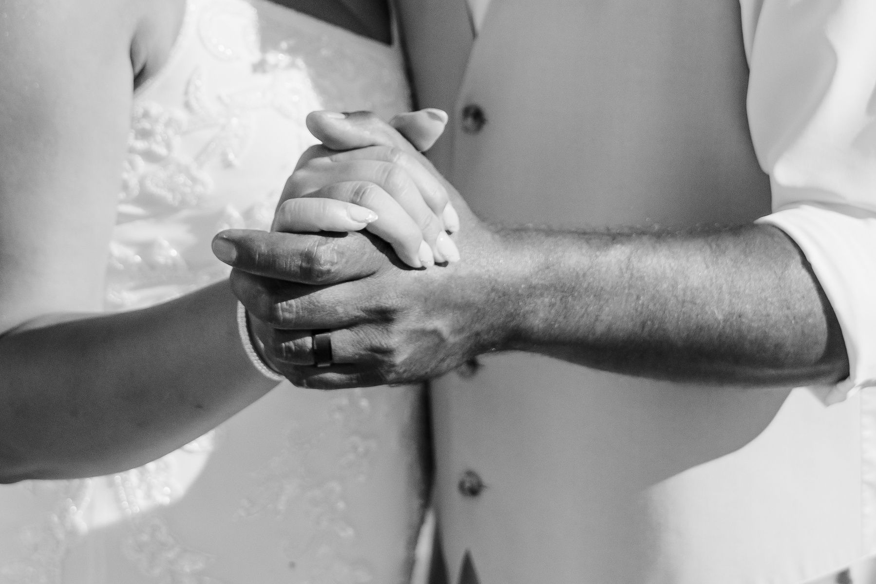 black and white artistic close up of hands during first dance of husband and wife