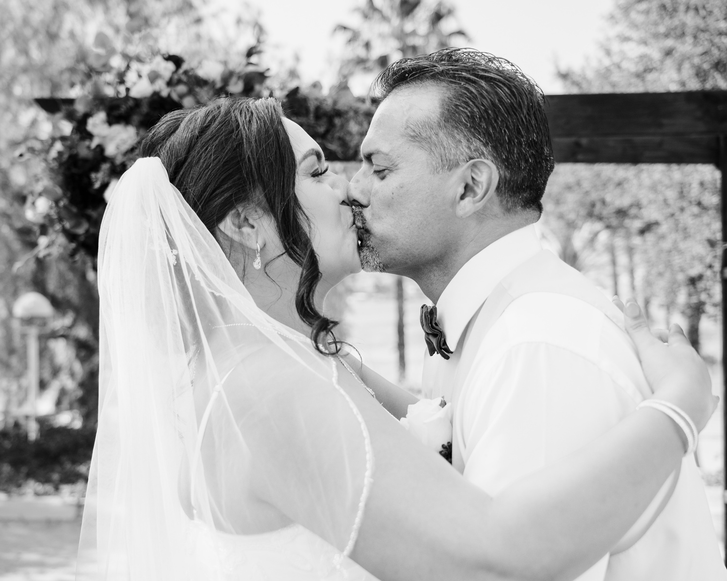 black and white bride and groom embrace and kiss at the altar 