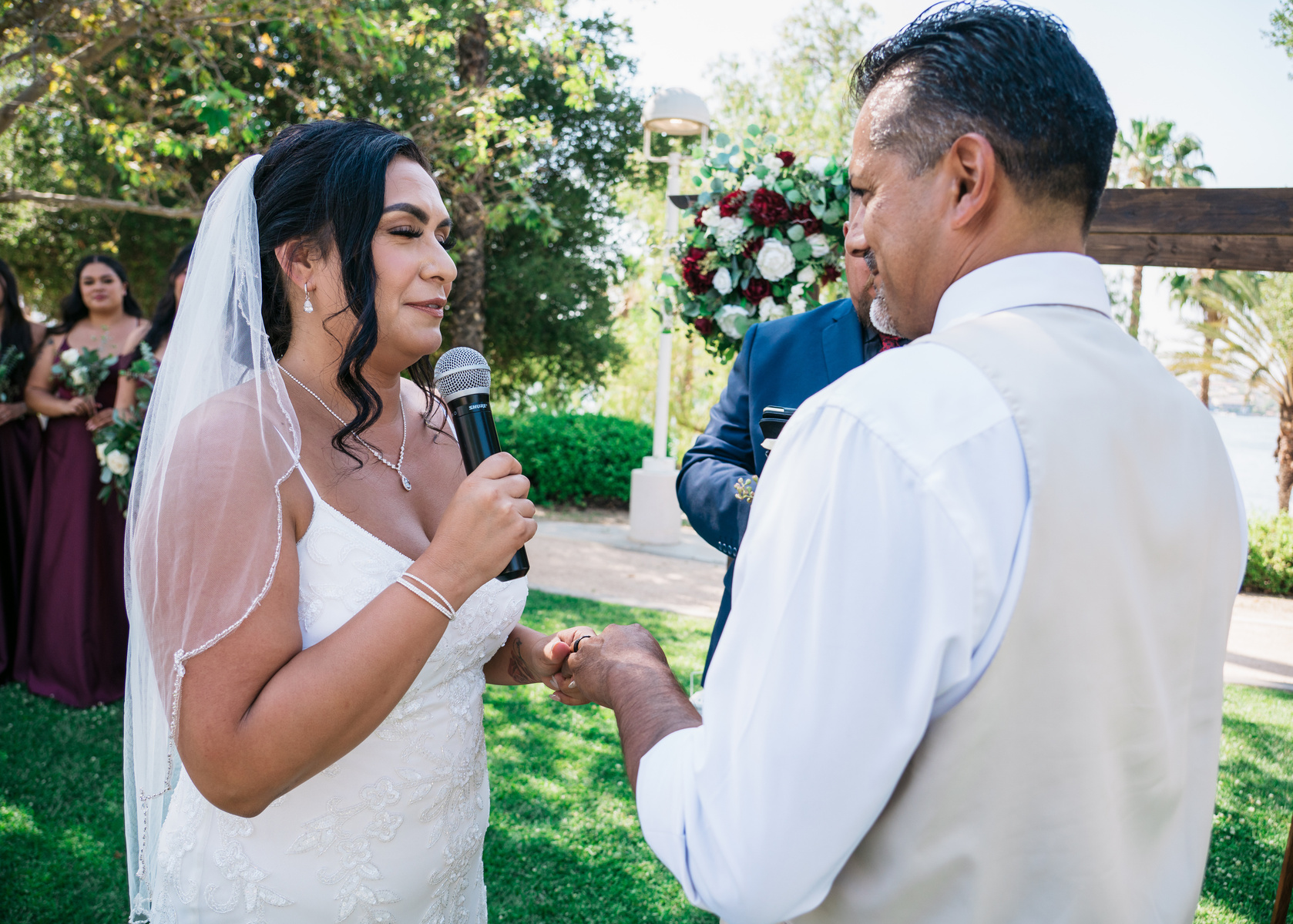 eyes closed holding hands the bride recites his vows to groom