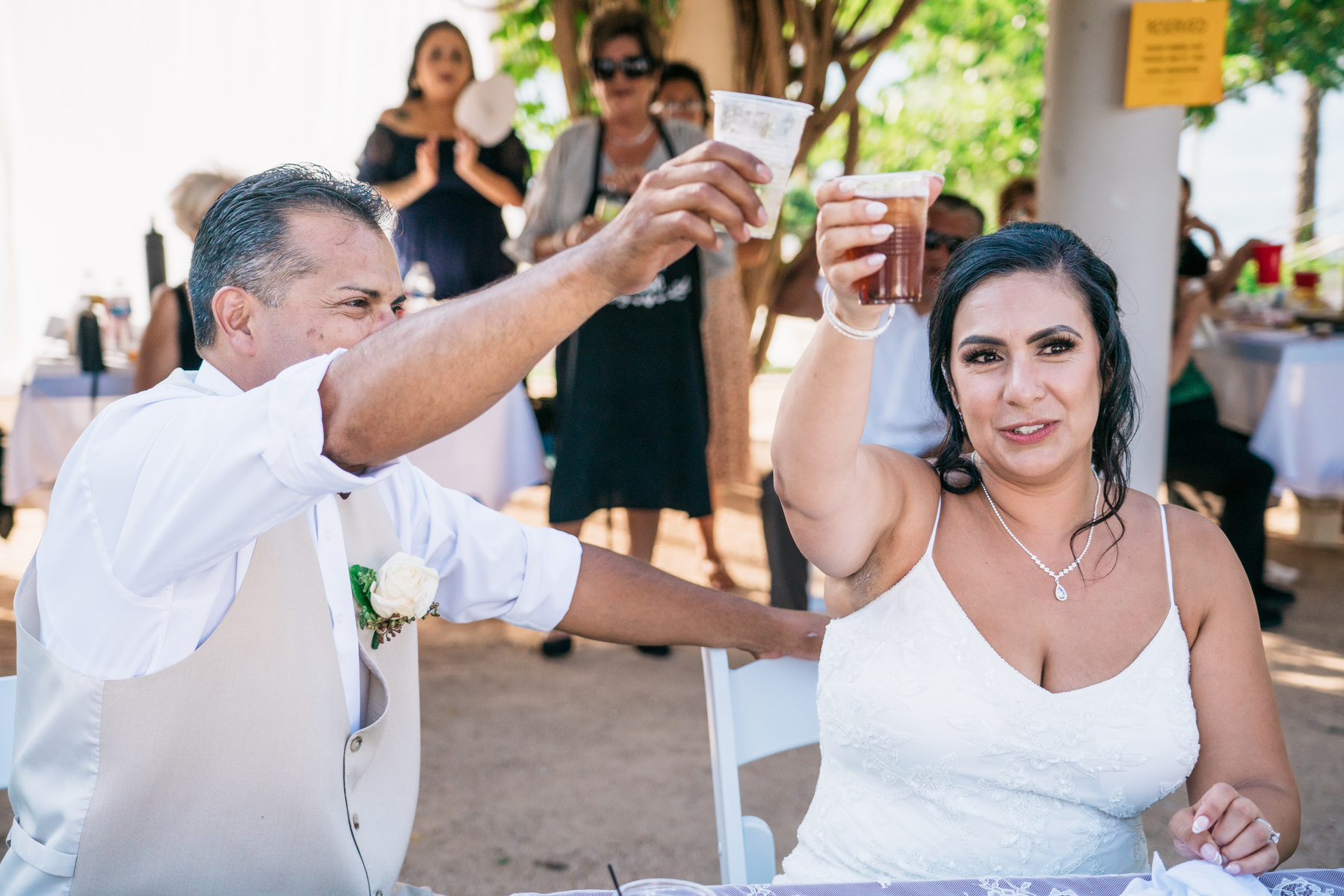 bride and groom husband and wife raise a glass in a toast 