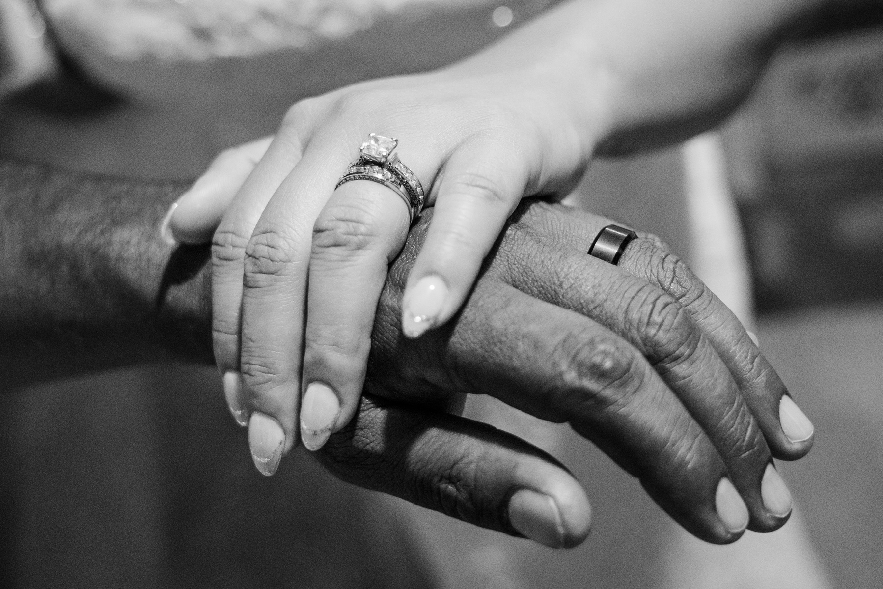 black and white bride and groom husband and wife hands wedding bands rings