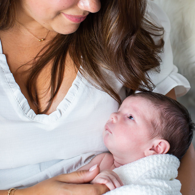 A mother and gazing into the eyes of her newborn baby.