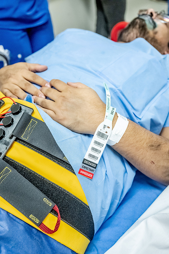 Close-up of triage tags on a simulated patient during a Mass Casualty Incident drill at Texas Health Presbyterian Hospital Dallas - showing the START triage system with Deceased, Expectant, and Immediate priority classifications.
