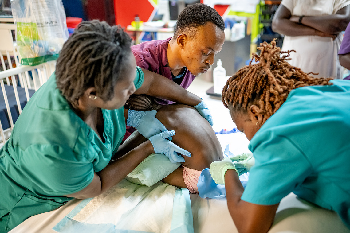 Guinean medical team providing compassionate pediatric care at the Sacré Coeur medical clinic in Guinea, West Africa.