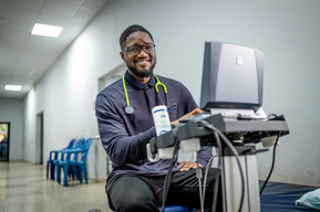 Guinean doctor using an echocardiogram machine for cardiac care at the Sacré Coeur medical clinic in Guinea, West Africa.