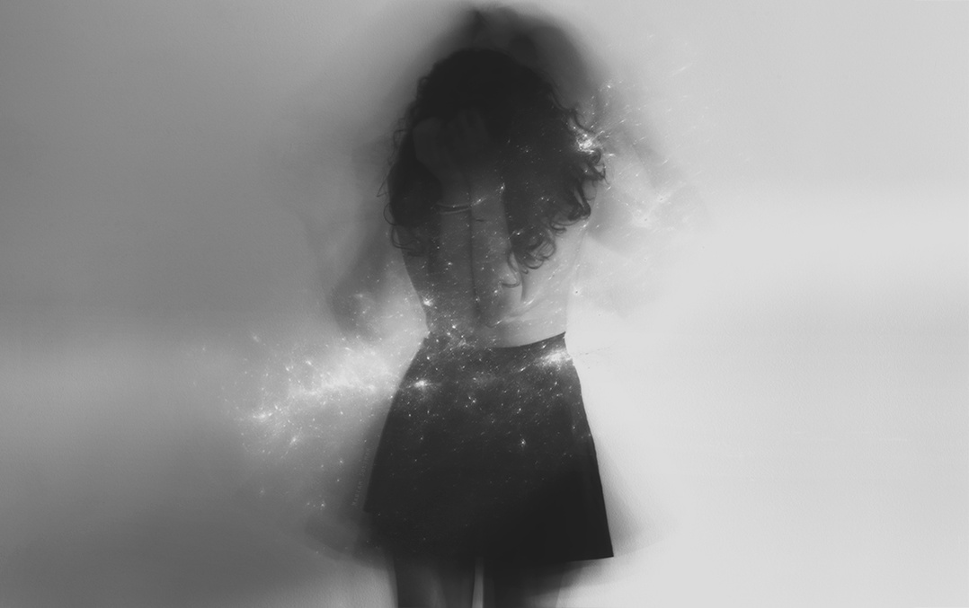 Dreamy and surreal black and white self portrait by young woman