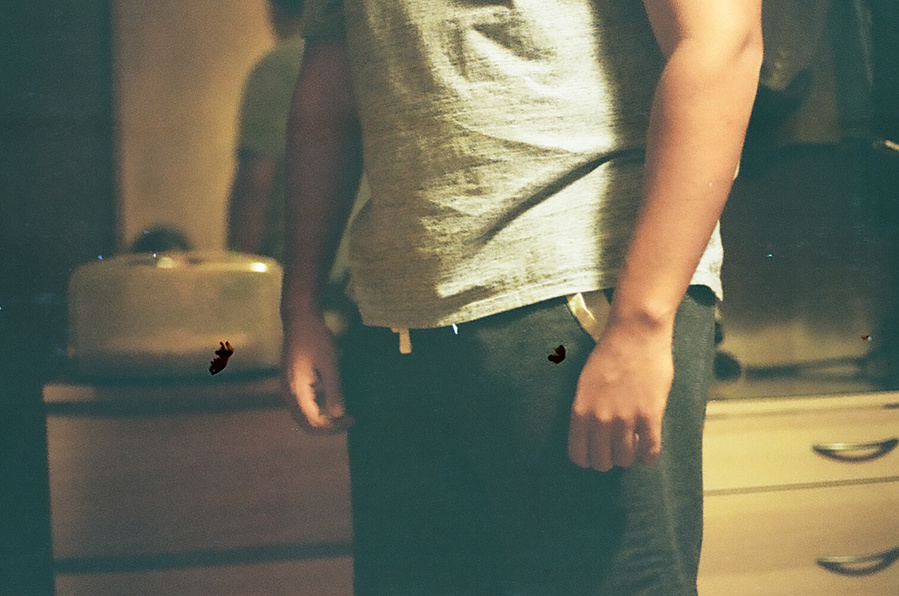 Intimate analog photograph of young man in bedroom 