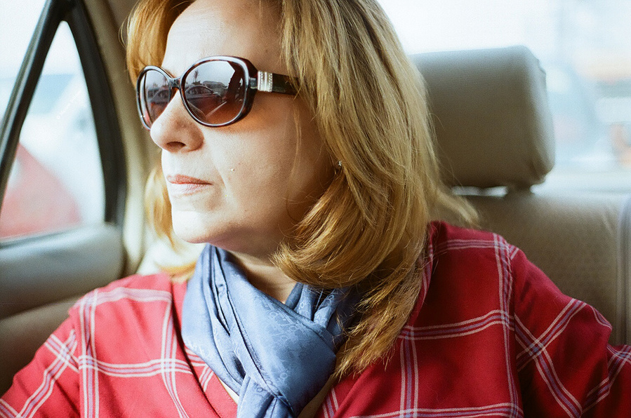 Analog portrait of woman in car