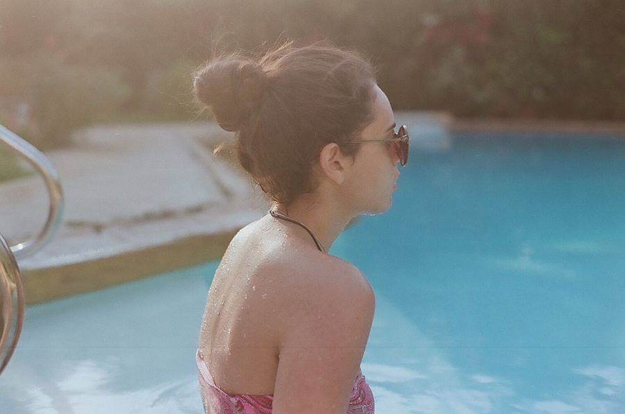 Soft Analog Summer Portrait of a young woman by the pool