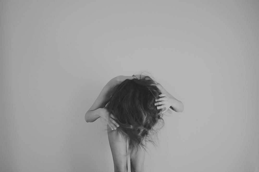 Black and white self portrait of nude young woman