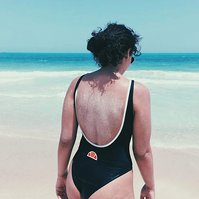 Photograph of young woman in ellesse bathing suit by the beach, taken with iPhone SE (1st gen)
