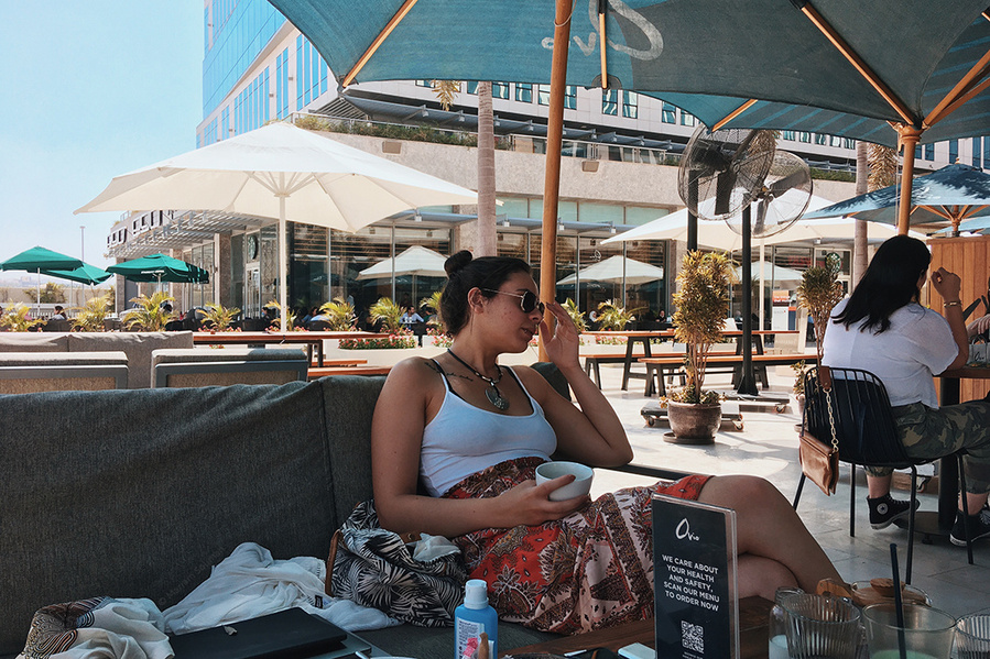 Photograph of stylish girl sitting in restaurant in Cairo, Egypt, taken with iPhone SE (1st gen)