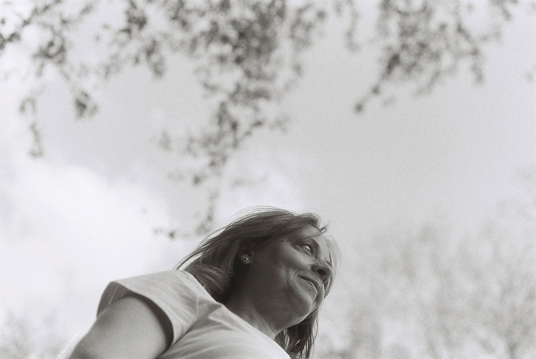 Black and white analog portrait of woman in nature with dreamy bokeh