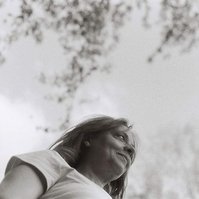 Black and white analog portrait of woman in nature with dreamy bokeh