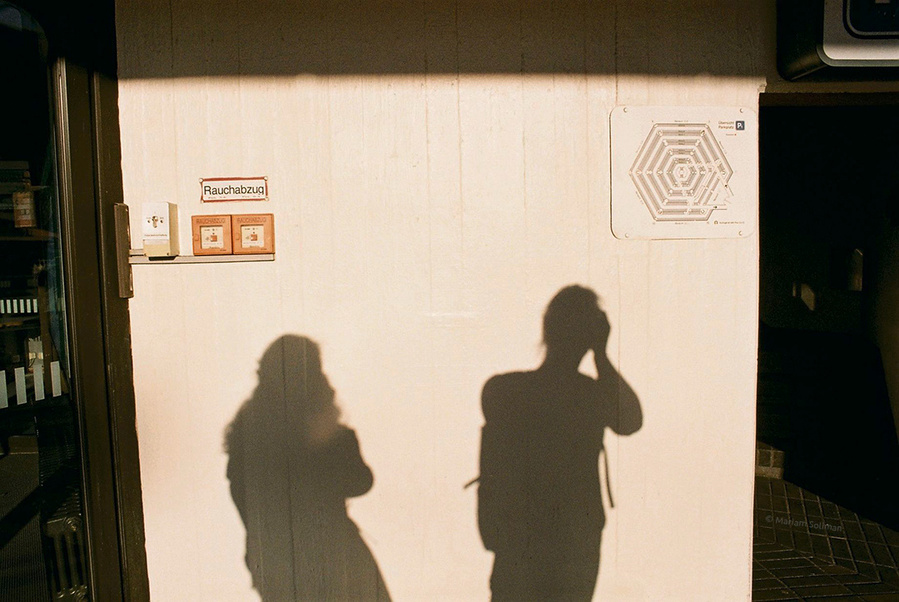 Shadows of two photographers falling on wall in Berlin Tegel Flughafen