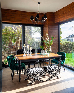 interior with wooden dining table and green chairs