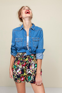 photo model in denim shirt and shorts on plain background
