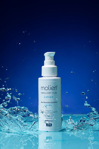 cosmetic skin lotion product on blue turquoise background with water splash