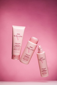 cosmetic hair products flying on pink background
