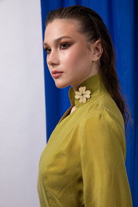 photo model in green dress on blue background