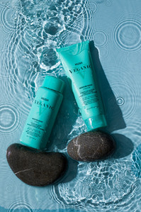 shampoo and conditioner on pebbles and water