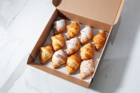 little croissant in box on a marble table