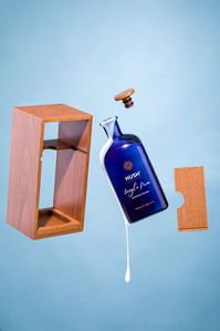 hair cosmetics product on blue background mid air