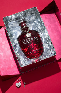 shiny glass red hair cosmetics bottle on red background 