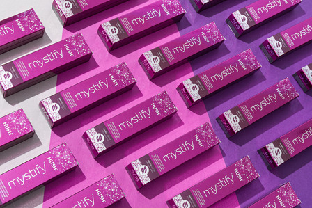 hair color product packages on pink purple background
