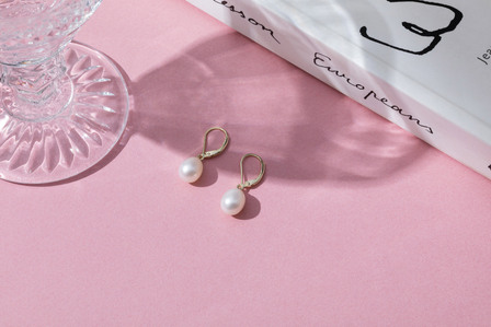 pearl jewelry earrings on pink background
