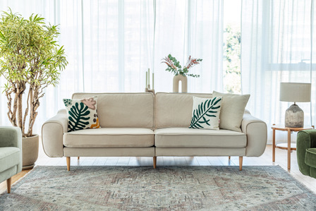 beige sofa a rug on a room setting