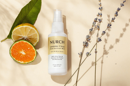 cosmetic product bottle with orange and lemon slices