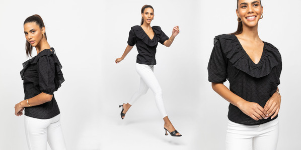 photo model in white pants and black shirt on white background