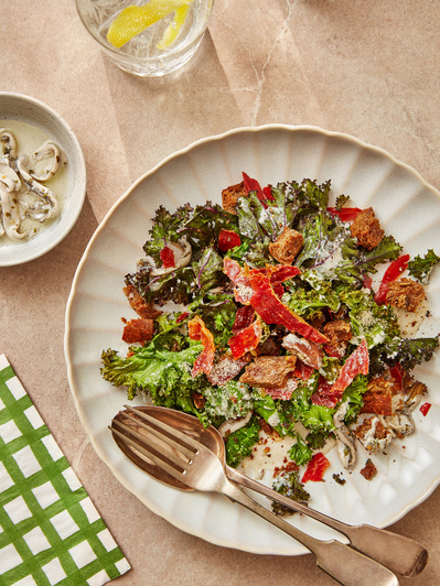 Kale salad with dappled light on a stone background, perfect for editorial, advertising and restaurant food photography, shot by food photographer, Sid Ali