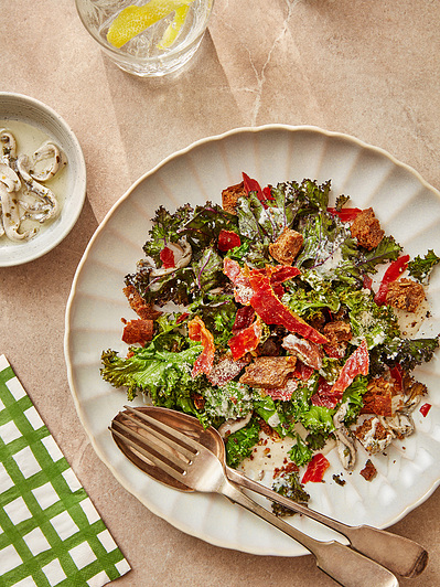 Kale salad with dappled light on a stone background, perfect for editorial, advertising and restaurant food photography, shot by food photographer, Sid Ali